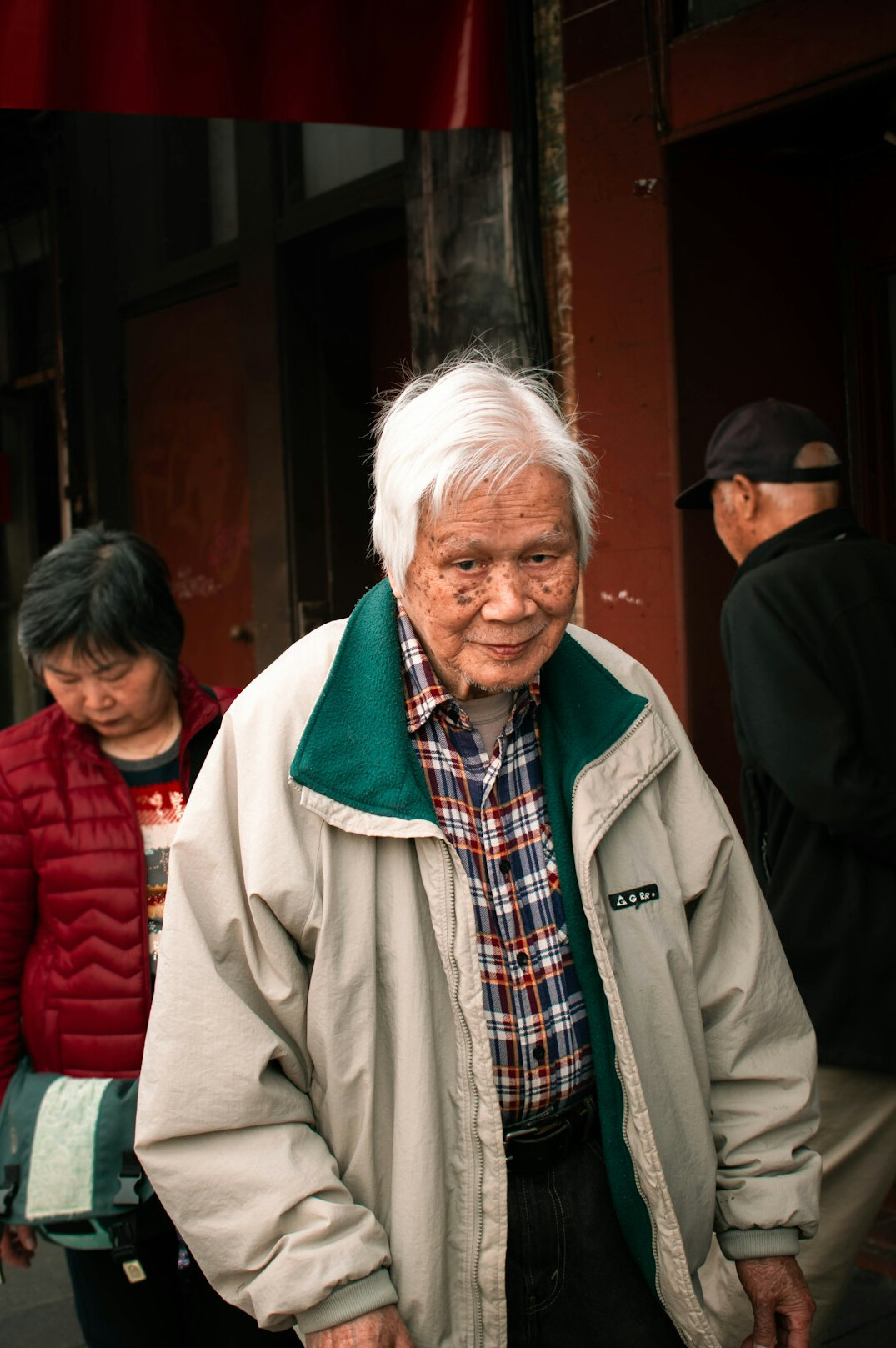 Older woman with gray hair and glasses smiling
