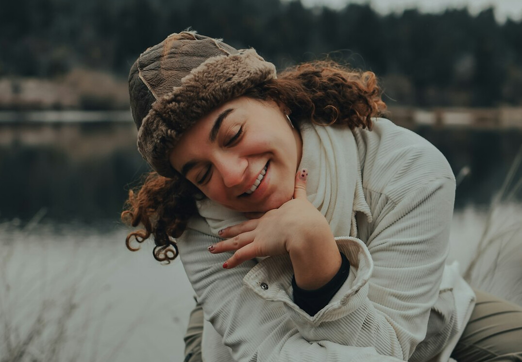 Smiling woman with wavy brown hair portrait
