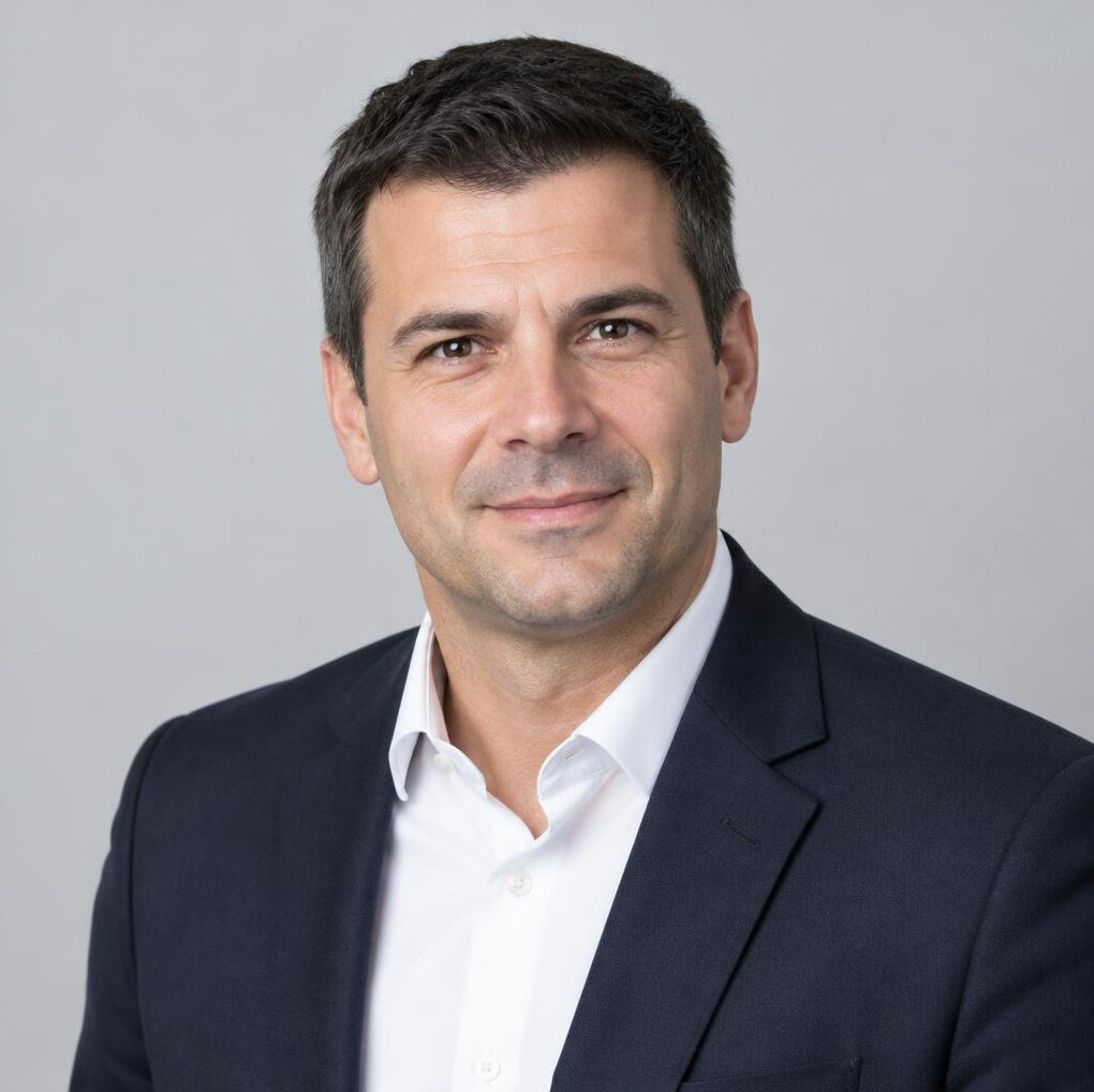 Man in a dark blazer smiling portrait